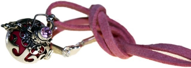 A filigree silver orb pendant, accented with a pink gem and interior, hangs from a knotted pink suede cord against a white background.