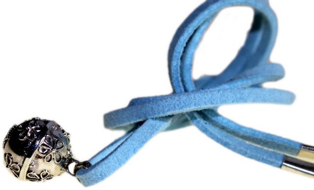 A silver, flowered sphere dangles at the end of a knotted, light-blue suede cord. The object is posed in a clear, bright, white space.