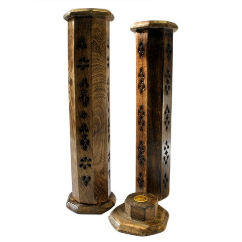 Two vertical wooden incense holders with decorative cutouts stand on a flat surface. One holder appears to have a partially lifted lid, revealing space for incense placement.