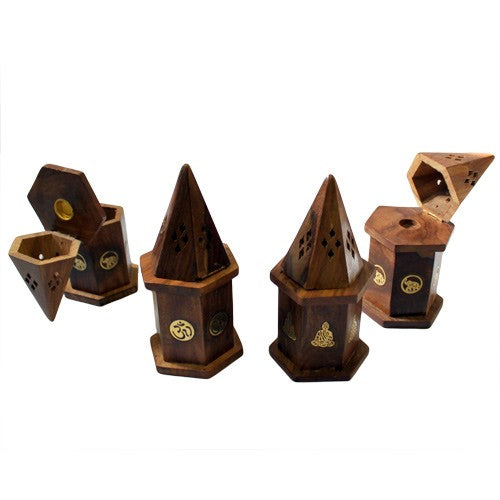 Wooden incense holders with hexagonal bases and removable conical tops feature engraved symbols like an Om and a Buddha. They are arranged in varied portions on a plain white background.