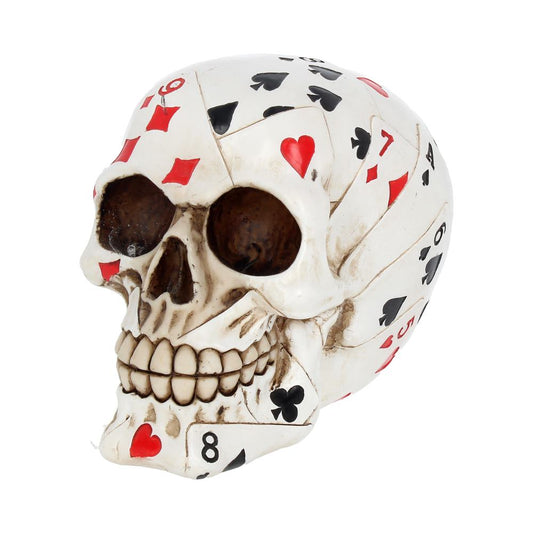 A skull adorned with playing cards, featuring various suits and numbers, creates an artistic and intriguing composition. The background is plain, emphasizing the skull's unique design.