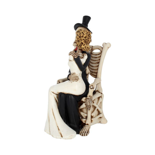 A skeleton couple in wedding attire sit on a chair made of bones. The groom wears a top hat and hugs the bride. The scene is isolated on a white background.