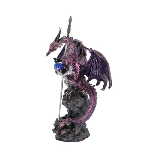 A purple dragon figurine, clutching a blue orb, is perched atop a rock formation surrounding a sword; the scene is presented against a stark white background.