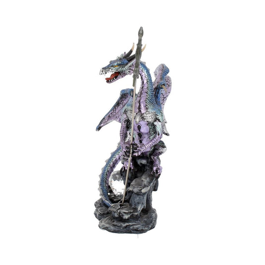 A purple and blue dragon figurine sits perched atop a gray rocky base, holding a silver spear. The figurine is presented against a white background.