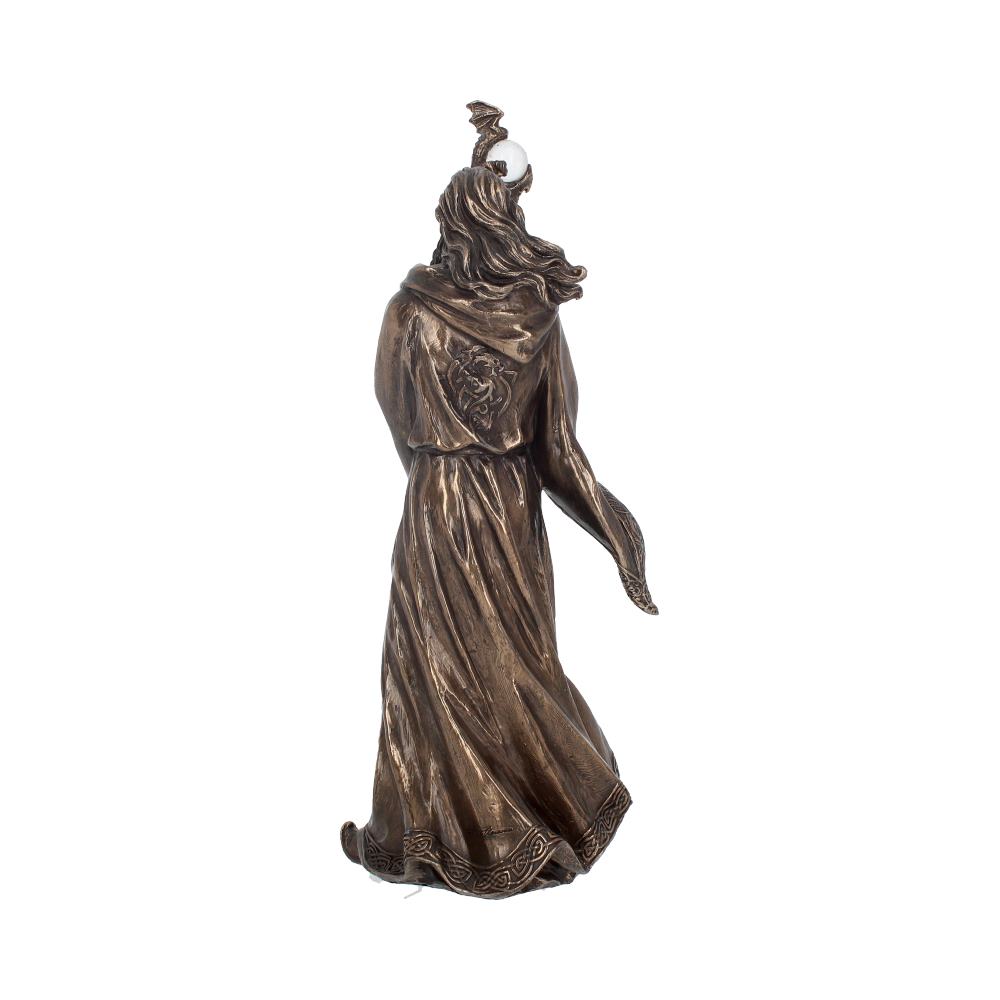 Bronze-colored statue of a robed figure with flowing hair holds a staff topped with an orb. The figure appears mid-stride, adorned with intricate patterns, against a plain white background.