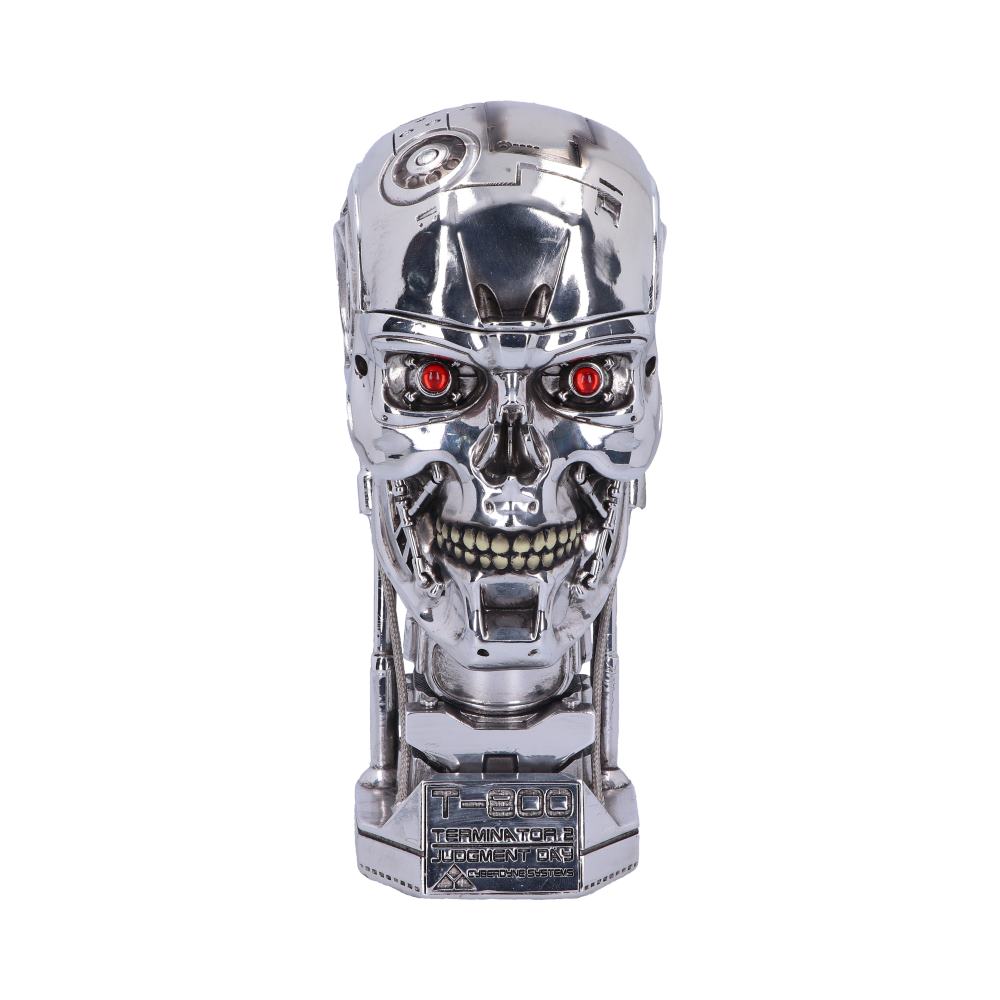 A metallic robot skull with glowing red eyes is positioned centrally. It is highly detailed, featuring complex mechanical components. Below, text reads "T-800 TERMINATOR 2 JUDGMENT DAY CYBERDYNE SYSTEMS."