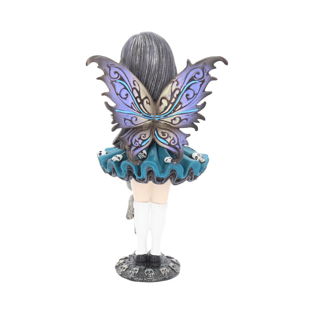 A fairy statuette stands, displaying detailed, iridescent purple and blue wings. She wears a teal dress with skull accents, white stockings, and stands on a skull-covered base against a white background.