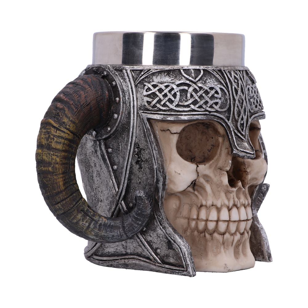A skull-shaped mug adorned with intricate silver Viking helmet details and a horn handle, set against a plain white background.