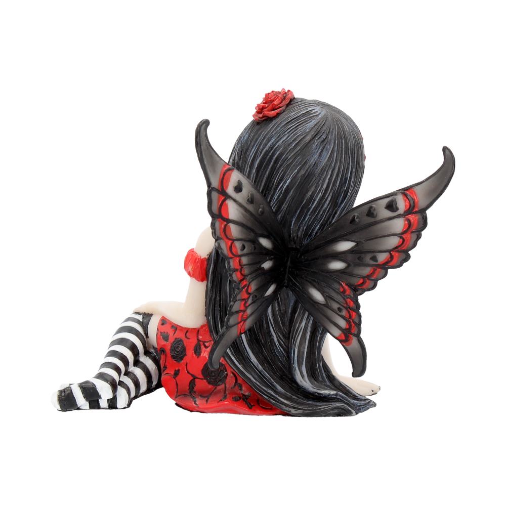 A fairy figurine sits with black and red butterfly wings extended. She has long black hair, a red dress with black patterns, and striped stockings, against a plain white background.