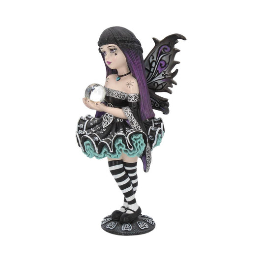 A fairy figurine stands on a patterned base, holding a crystal ball in her hands. The fairy has purple hair and dark wings, and she wears a black dress with striped tights.