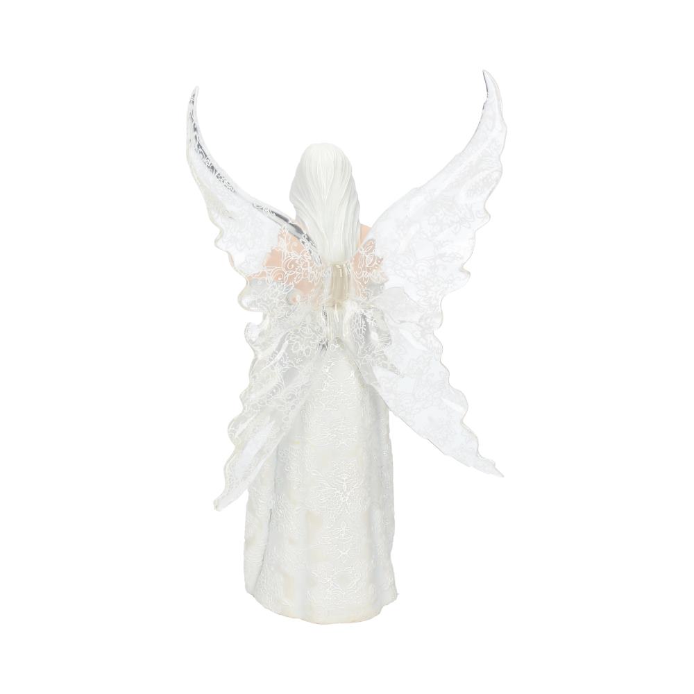 An angel figurine stands with elaborate lace wings spread wide, clad in a long, textured white gown. The scene is isolated against a plain white background.