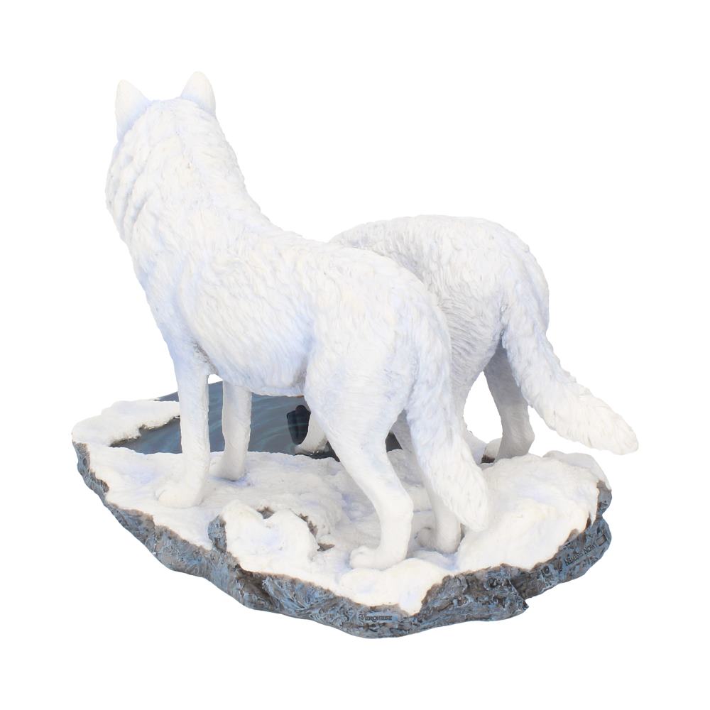 Two white wolf sculptures stand on a snowy base, facing away. Surrounding them is a textured surface resembling a wintry landscape.