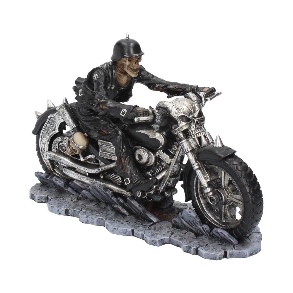 A skeletal biker, clad in leather, rides a skull-themed motorcycle along a cobblestone road.