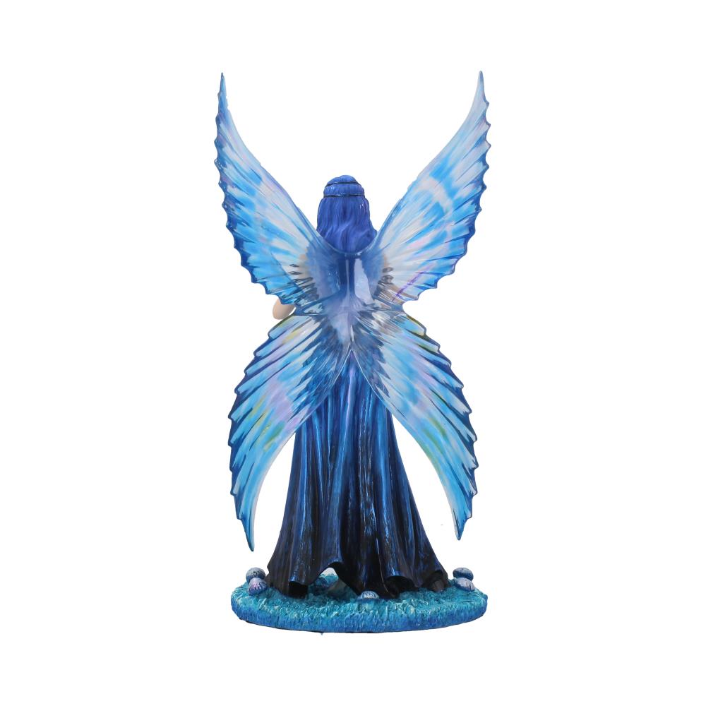 A fairy-like figure stands, displaying large, translucent blue wings, wearing a flowing blue gown. The scene is set against a plain, white background, highlighting the figure's colors.