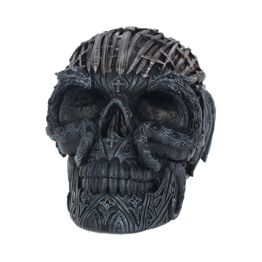 A detailed, metallic skull features intricate engravings and raised patterns; it's crafted to resemble a mix of armor and ornate designs, emphasizing a gothic aesthetic in a plain white background.