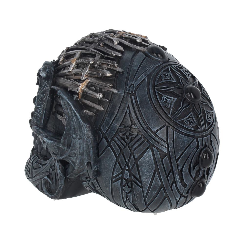A detailed, carved skull featuring intricate patterns and embedded swords, showcasing an ornate design. The skull sits in a white, unobtrusive environment with no surrounding objects.