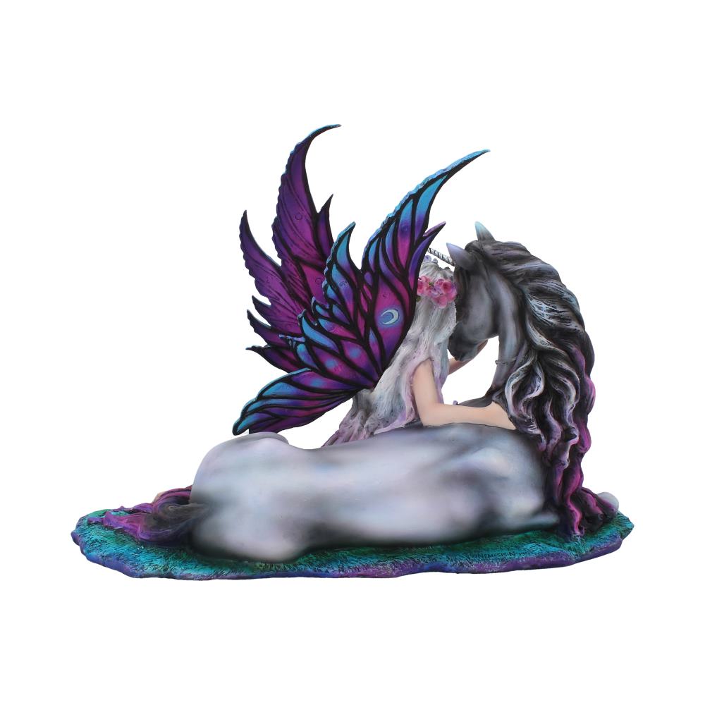 A fairy with purple wings sits next to a unicorn, embracing it. The scene is captured on a textured, multicolored base against a plain white background.