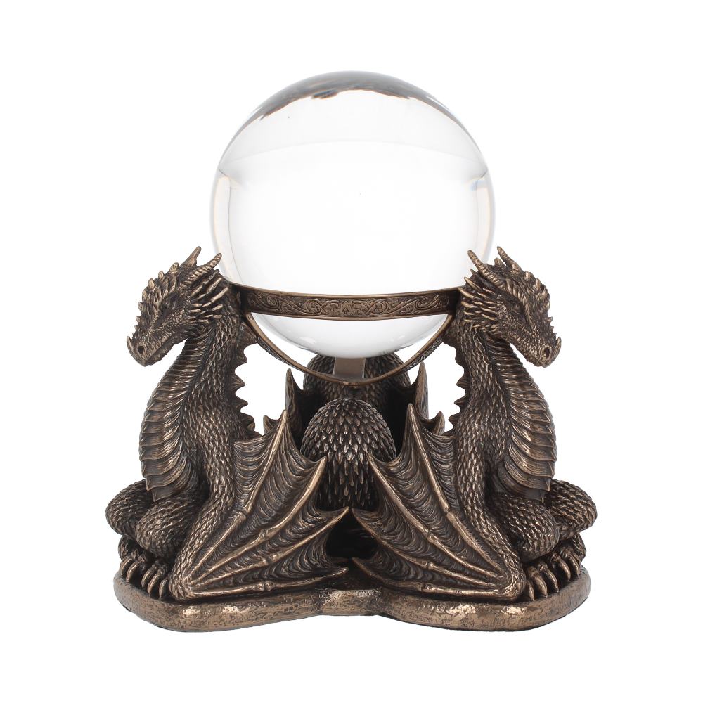 A clear crystal ball sits cradled by two bronze-colored dragons in a decorative bronze frame. The dragons perch protectively, wings spread, on a small base. The background is a uniform white.