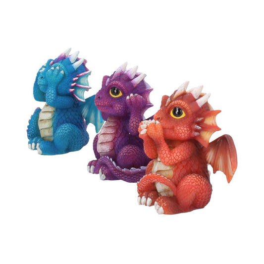 Three small, colorful dragon figurines sit playfully. The blue dragon covers its eyes, the purple covers its ears, and the red covers its mouth, all against a plain white background.