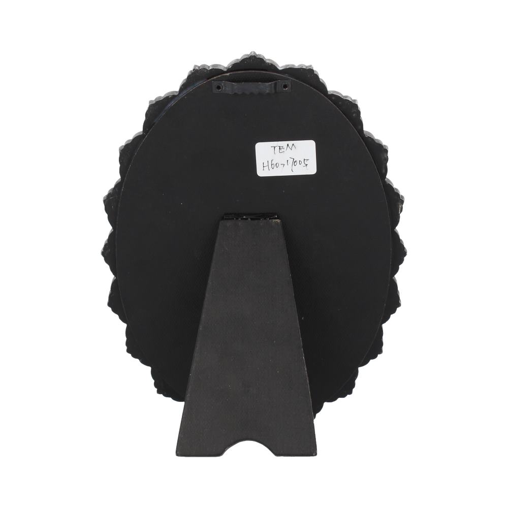 A round, ornate black frame stands on a small easel. A label on the back reads: "TEM H607/7005".