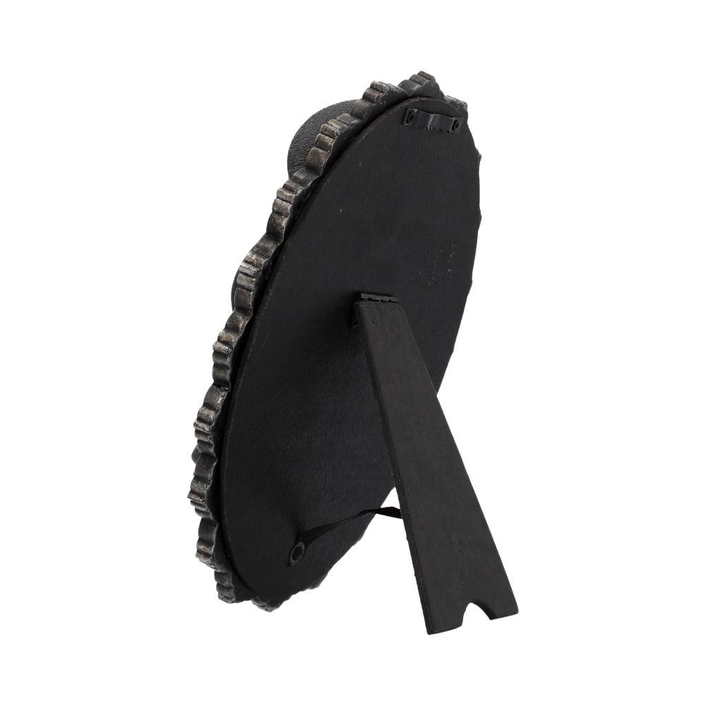 A dark, ornate oval picture frame stands on a simple black easel, on a white background.