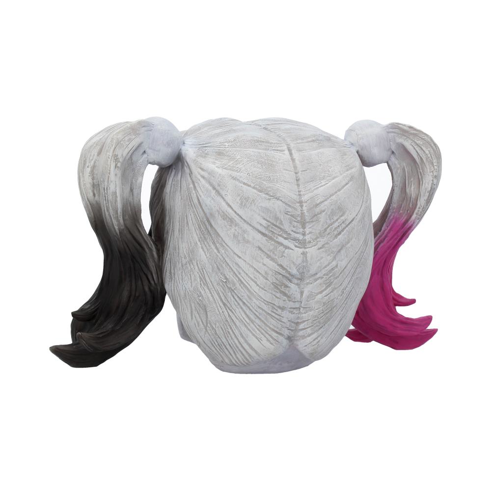 A wig with two pigtails, one dyed black and the other pink, placed against a plain white background.