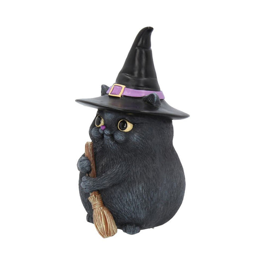 A chubby black cat figurine wearing a pointy witch hat with a purple band holds a small broomstick. It stands on a plain white background.