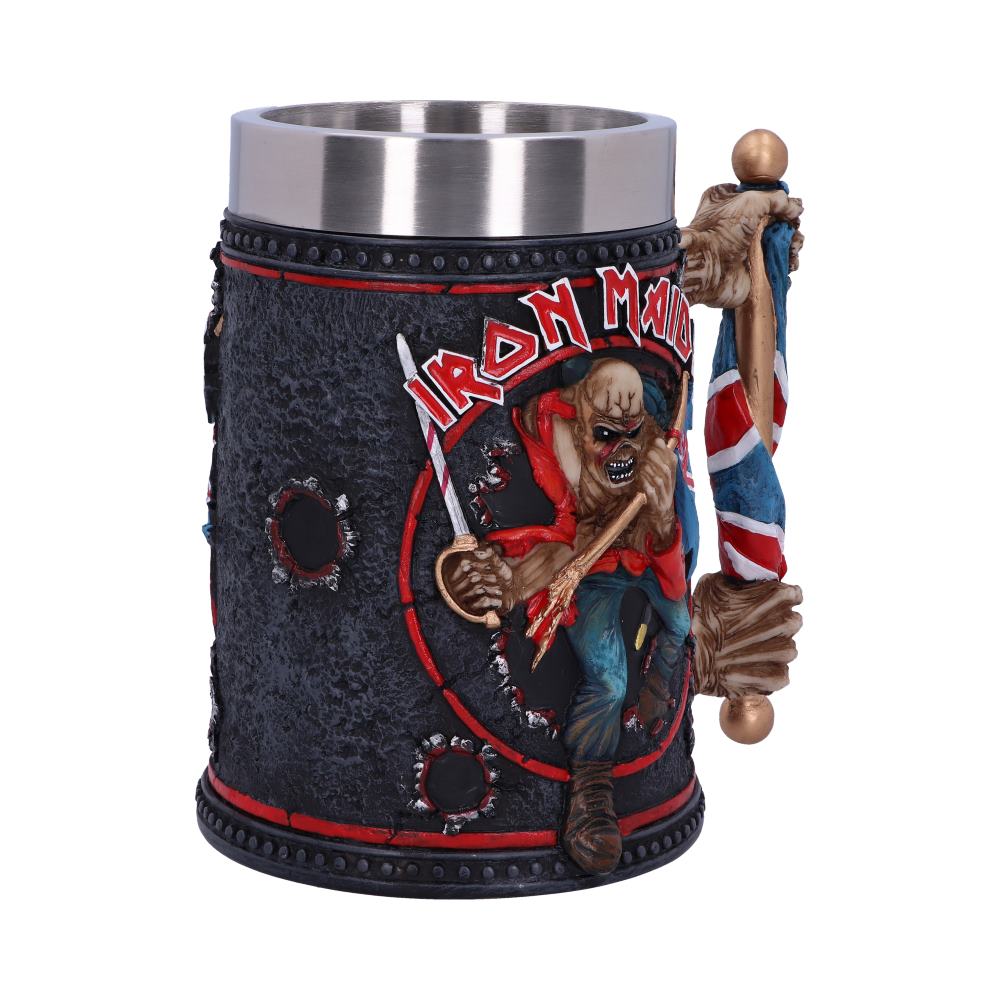 A metal tankard features a raised, detailed depiction of a skeletal warrior holding a flag. The text "Iron Maiden" is emblazoned in bold letters against a rough-textured background.
