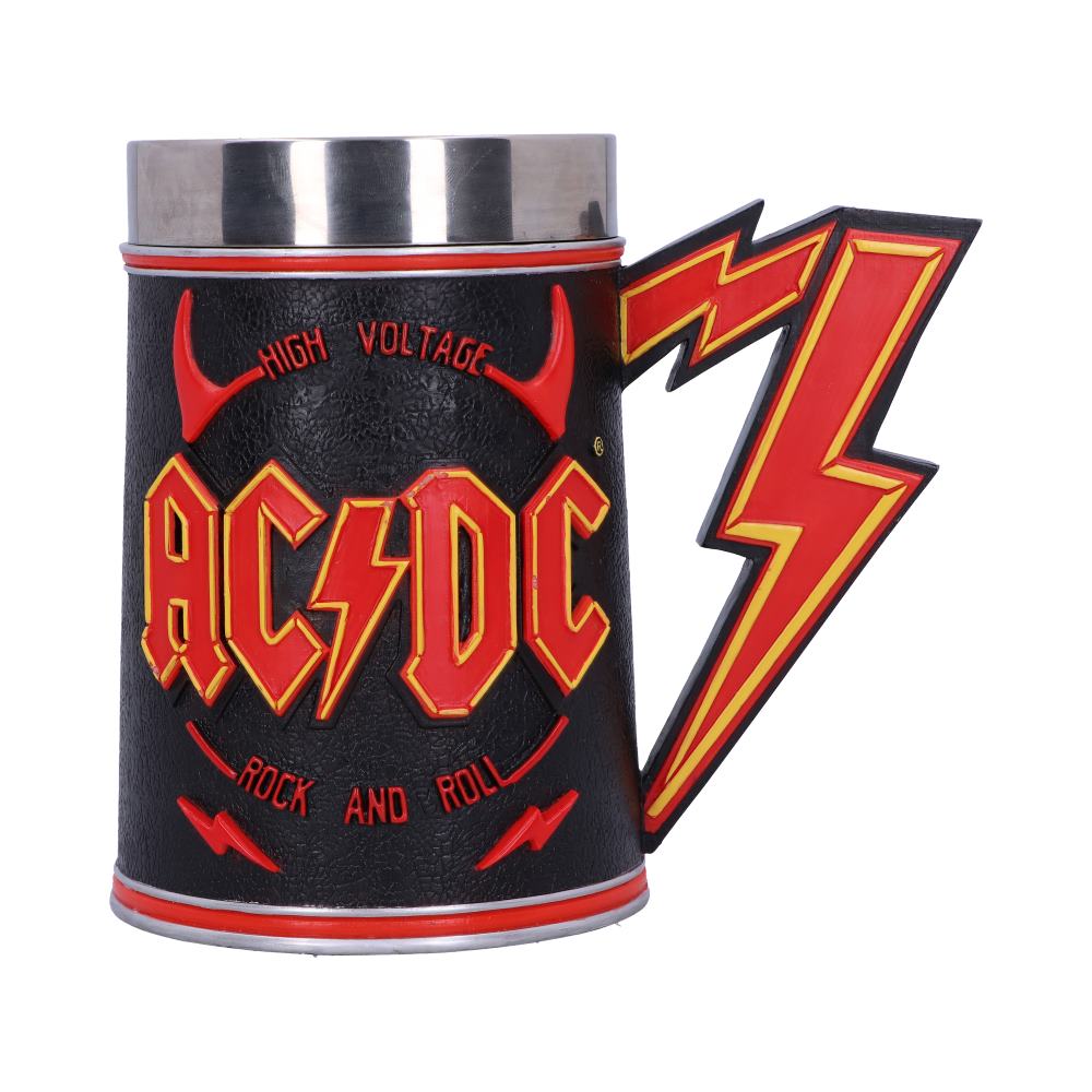 A black mug with red and yellow lightning bolt handle features the text "HIGH VOLTAGE AC/DC ROCK AND ROLL," set against a plain white background.