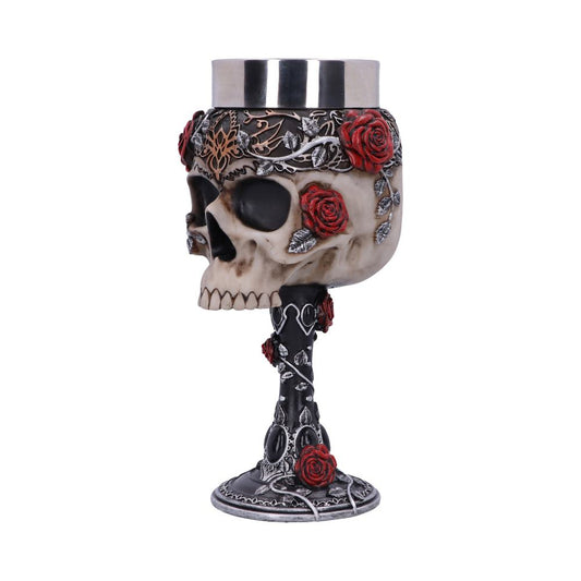 A decorative goblet features a skull design adorned with red roses and silver leaves. The skull forms the cup part, while the stem and base continue the floral motif.
