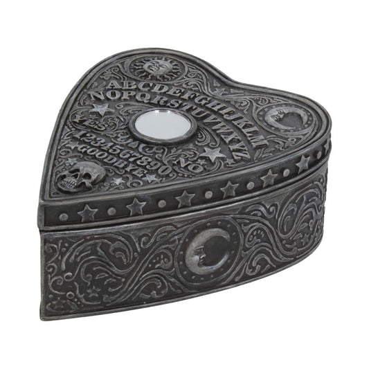 Heart-shaped metallic box featuring ornate engravings and symbols. Engraved text includes letters A-Z, numbers 0-9, "YES," "NO," "GOODBYE." Decorated with stars, a skull, a sun face, and a crescent moon.