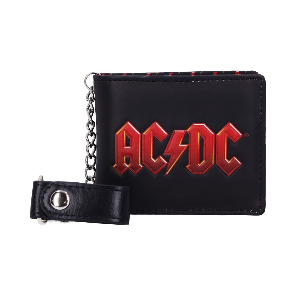 A black wallet displays the text "AC/DC" in bold, red lettering. It features a metal chain with a leather loop, set against a plain white background.