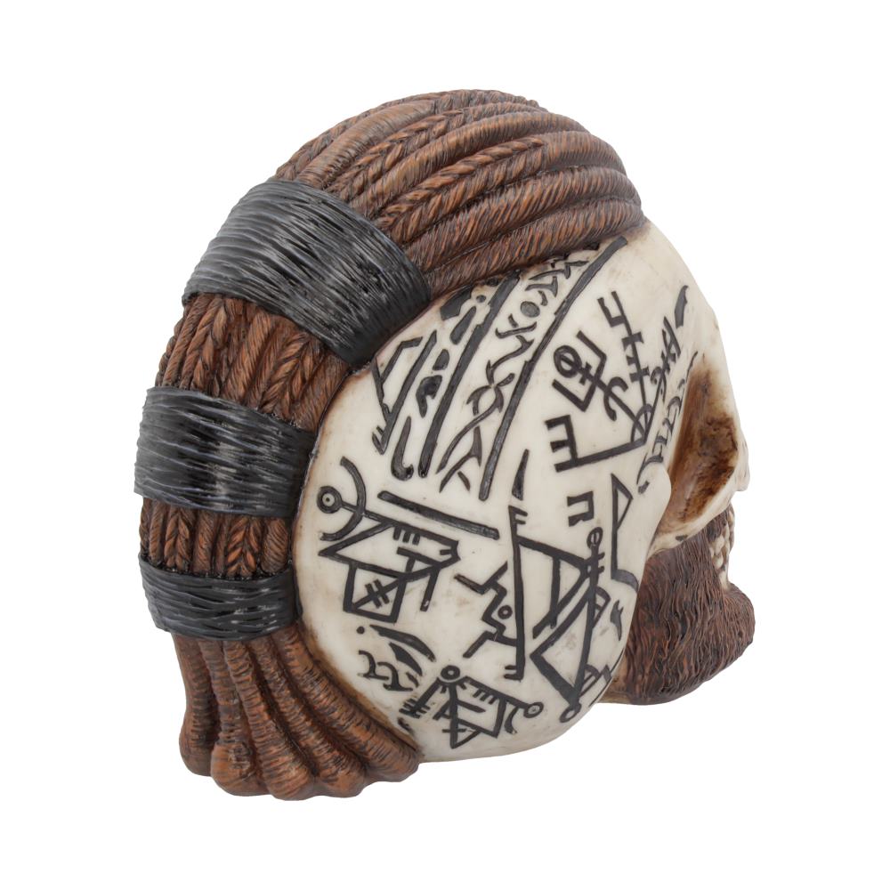 A decorative skull features detailed tribal carvings and symbols on its surface, with braided, rope-like textures simulating hair. The object is displayed on a plain white background.
