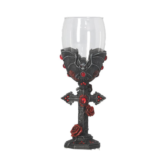 A clear goblet with a bat design at its base rests on a gothic, cross-shaped stand adorned with roses and red gemstones. The background is plain white.