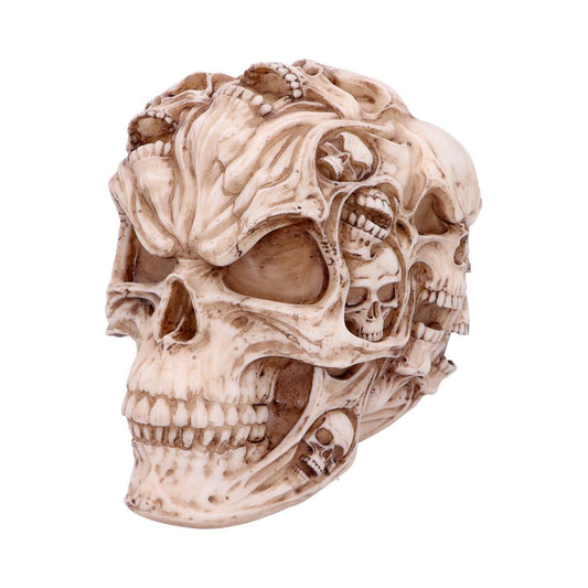 A detailed sculpture of a skull, intricately carved with smaller skull designs, rests on a plain white background.