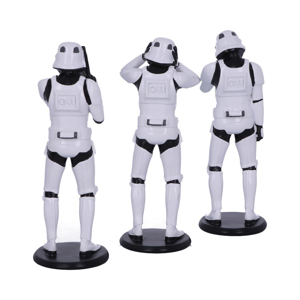 Three stormtrooper figurines in white armor positions: one covering ears, one covering eyes, and one covering mouth, resembling "see no evil, hear no evil, speak no evil." They're on black stands.