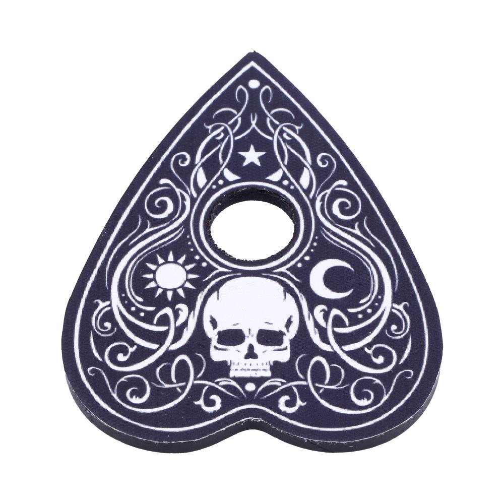 A planchette with a hole is decorated with white designs, including a skull, sun, moon, and swirling patterns, set against a dark background.
