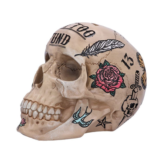 A decorative skull features tattoo-style designs, including a feather, rose, bird, skull with dagger, butterfly, and star. Text reads "TATTOO FUND" and number "13" in a creative setting.