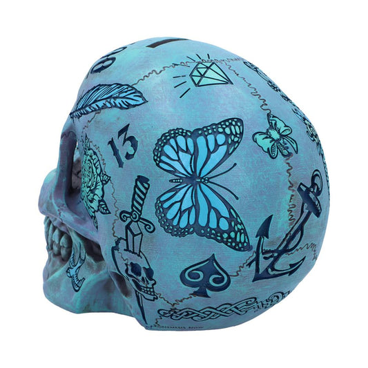 A decorative skull showcases various blue tattoo-style illustrations, including a butterfly, dagger, anchor, diamond, and number 13 against a light blue background, evoking a creative, artistic vibe.