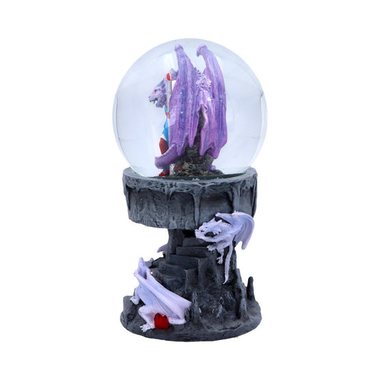 A snow globe featuring a purple dragon sits atop a dark, rocky base, two smaller white dragons are positioned at its sides.