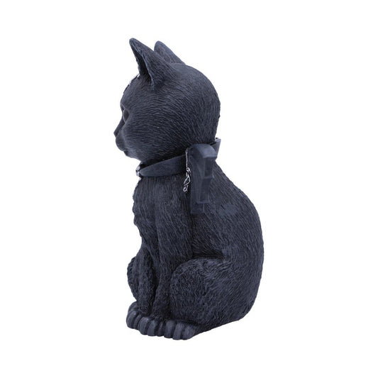 A black cat figure sits upright, facing left, adorned with a collar featuring a decorative element. The backdrop is plain white, highlighting the cat's textured surface.