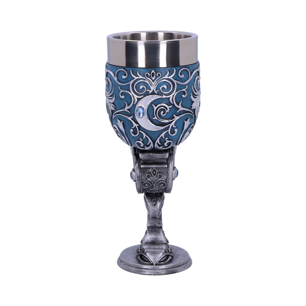 An ornate goblet sits on a white surface. It has a silver interior, a blue, patterned outer section, and a silver base, stem, and accents including a crescent moon.