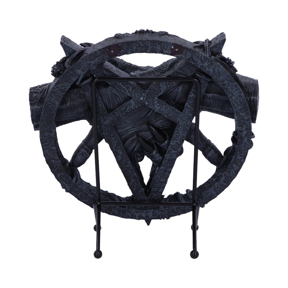 A dark, ornate stand features an intricate, gothic pentagram design with claw-like details. It rests on a simple three-legged base against a plain background, creating a dramatic visual contrast.