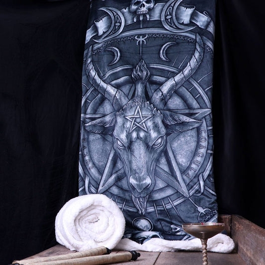 A blanket with a goat head and pentagram design hangs against a black background. The words "Solve" and "Coagula" are inscribed. A rolled blanket, parchment, and chalice rest below.