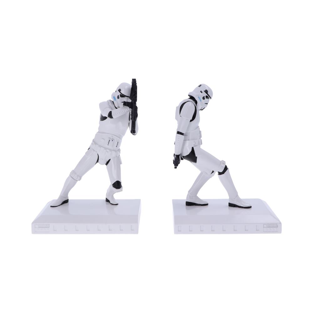 Two white-armored figures perform dance moves on separate platforms; one poses leaning back dramatically, while the other holds a rifle, also leaning back. They are against a white background.