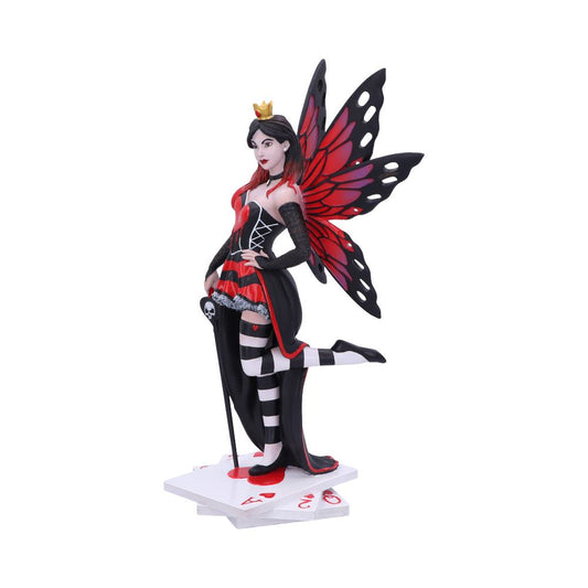 A fairy queen figurine strikes a playful pose on a stack of playing cards. She wears a red and black outfit with striped stockings and has red and black butterfly wings.