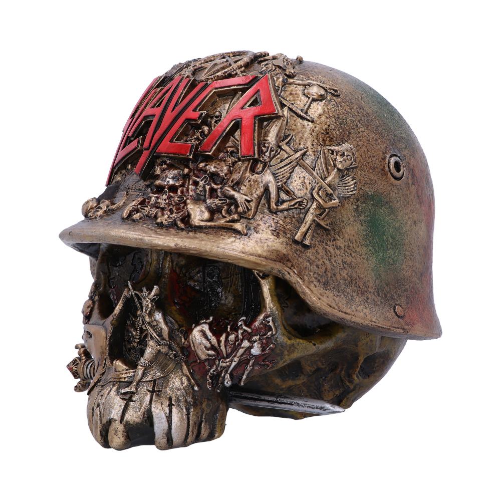 A skull adorned with a weathered military helmet. "SLAYER" is prominently embossed in red letters. The helmet features intricate sculpted figures and scenes, enhancing the skull's eerie appearance.
