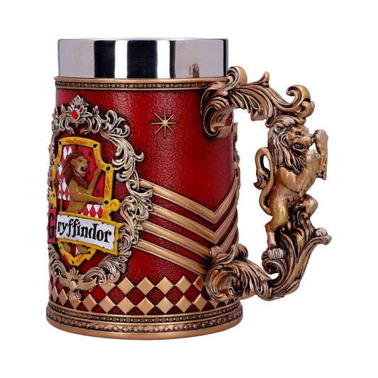 A decorative mug features a detailed lion handle and ornate embellishments, with a "Gryffindor" crest on a red background. The mug has gold accents and patterns, symbolizing bravery and elegance.