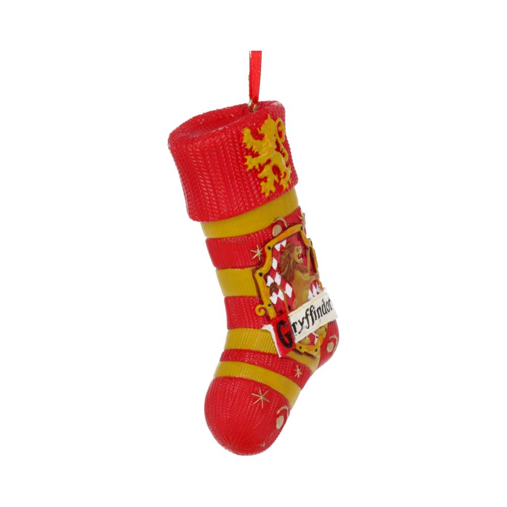 A red and yellow Christmas stocking ornament hangs, featuring a lion emblem and "Gryffindor" text, set against a plain white background.