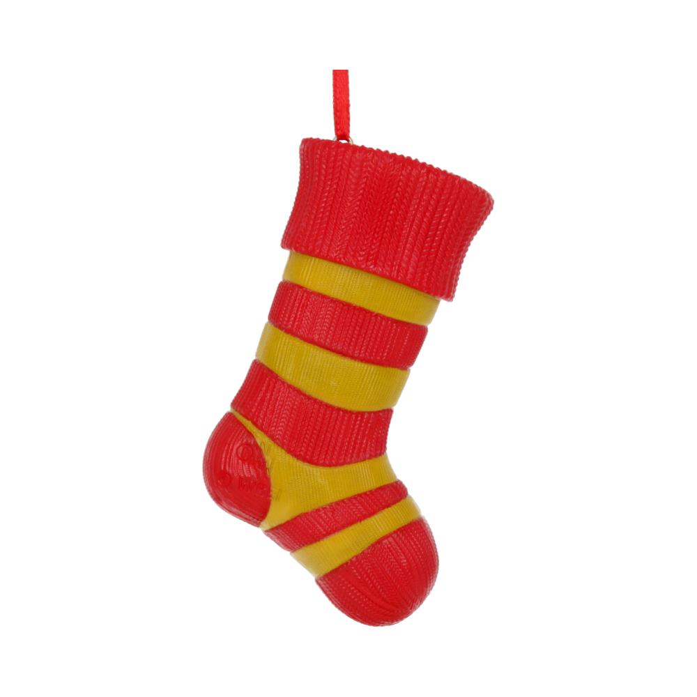 A plastic Christmas stocking, with alternating red and yellow stripes, hangs by a red loop against a plain white background.